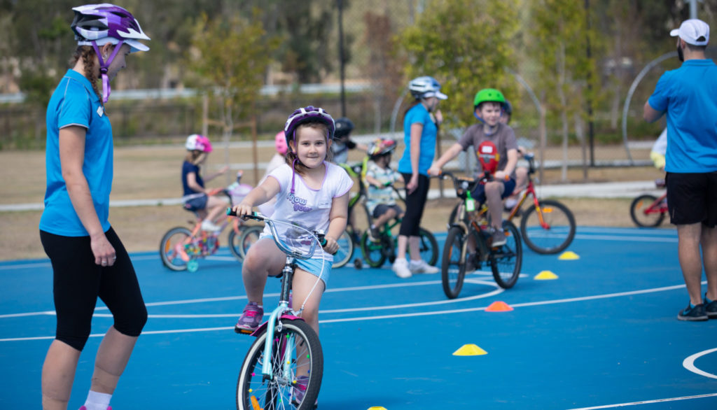Children learning to ride