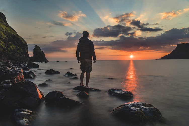 man looking at sunset