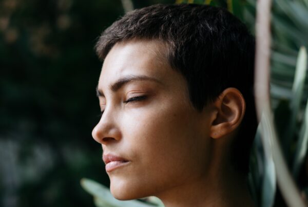 young woman with her eyes closed looking like she's meditating