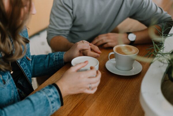 two people drinking coffee at a coffee shop