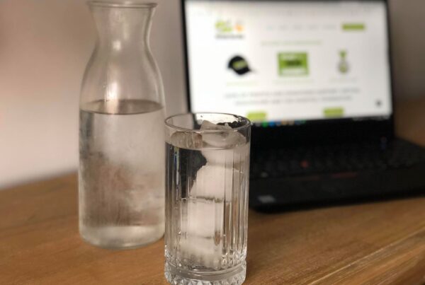 Glass of water with ice and a jug