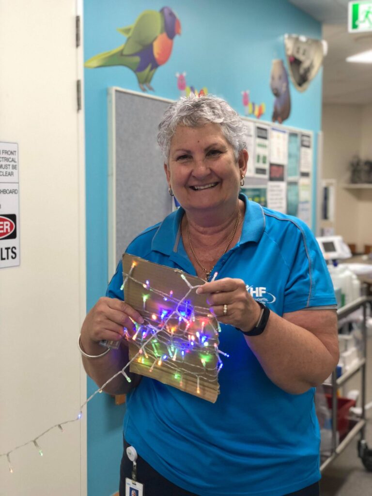 Volunteer, Joanne decorating the wards with Christmas Lights